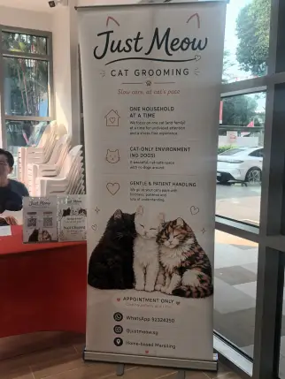 Just Meow stall promoting cat grooming and nail clipping.