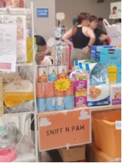 Sniff N Paw stall displaying pet food and supplies.