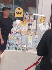The Kyat Parade stall displaying cat-themed gifts and accessories.