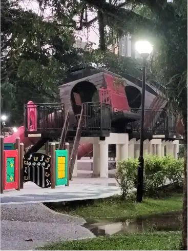 The tilted train playground in Tiong Bahru Park at dusk.